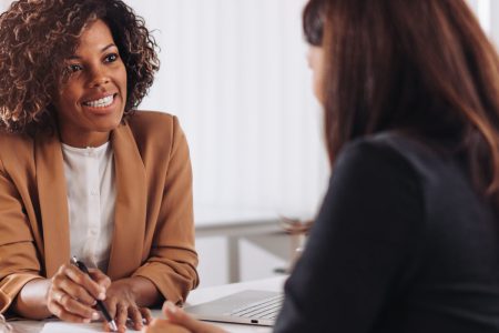 Female financial consultant manager talking with a client at the bank